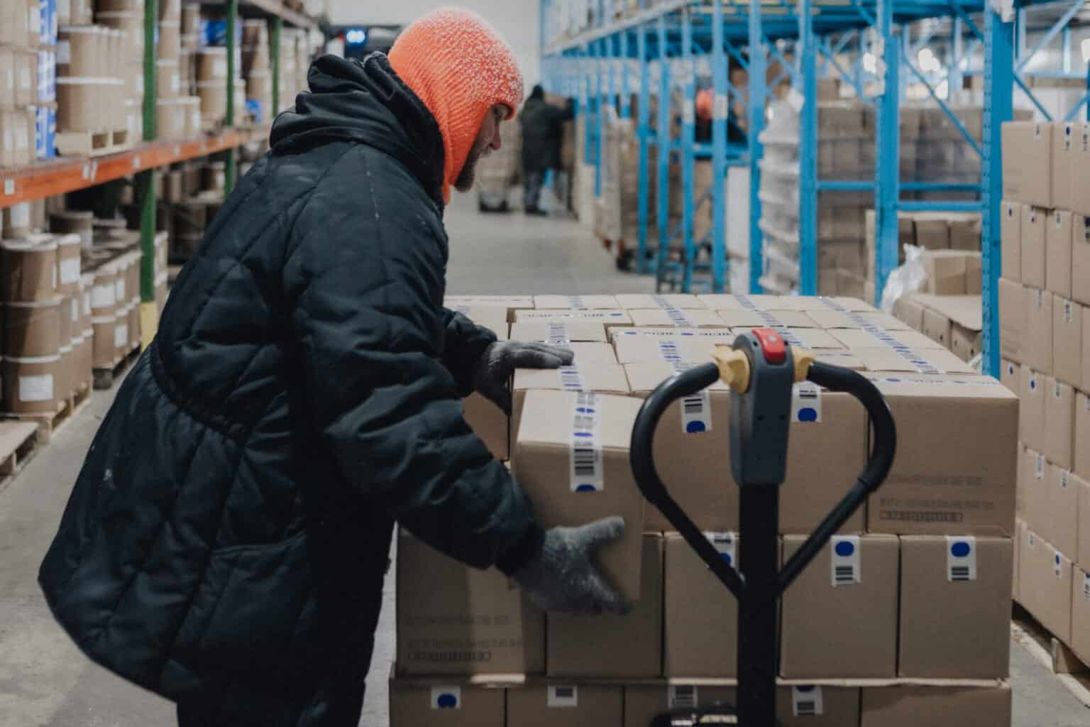 Worker moving cases of frozen ice cream through the DeConna distribution warehouse