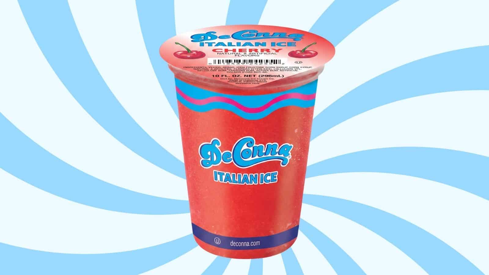 Front view of a bright red De Conna Italian Ice cup with cherry graphics and blue wave accents, set against a blue spiral background.