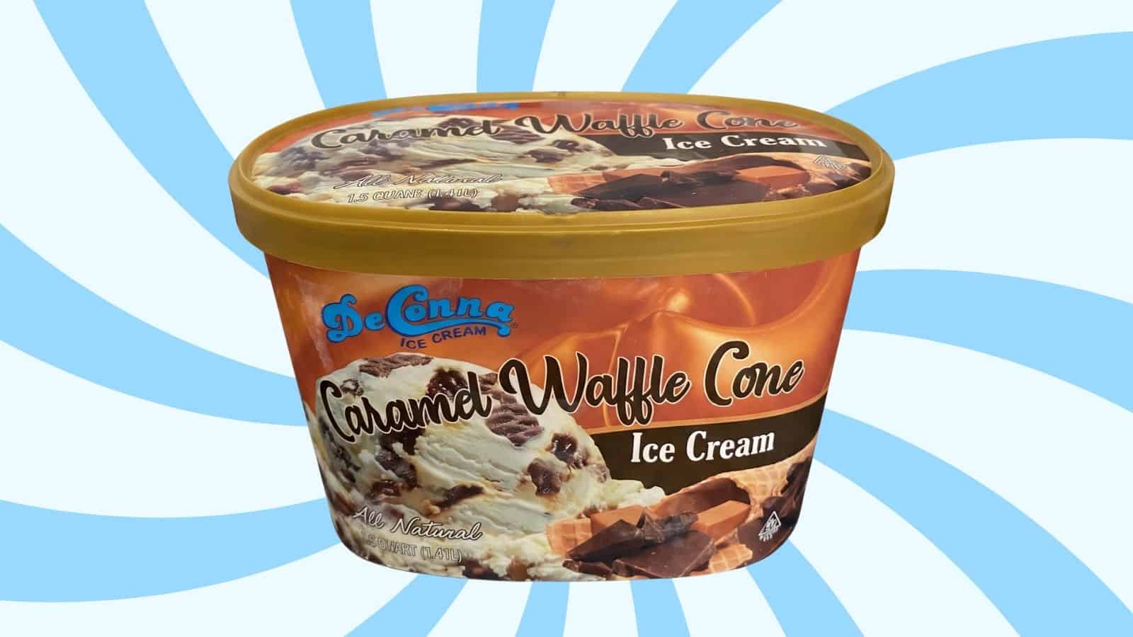 Caramel Waffle Cone ice cream tub with chocolate pieces on the scoop and DeCona brand, label says Caramel Waffle Cone Ice Cream.