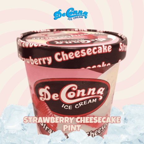 Strawberry-Cheesecake-Ice-Cream-Pint-DeConna DeConna Ice Cream Strawberry Cheesecake pint with pink container and bold logo, set on a pale pink background with ice cubes nearby.